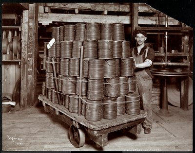 Interior view of a man working with leather at the New York Leather Belting Co., New York, 1906 by Byron Company